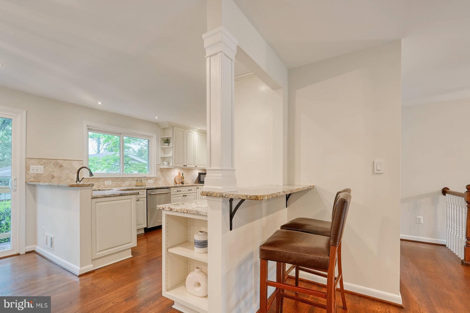 6511 Engel Drive McLean, VA 22101 - Photo 20 of 56 a kitchen with a table chairs cabinets and wooden floor