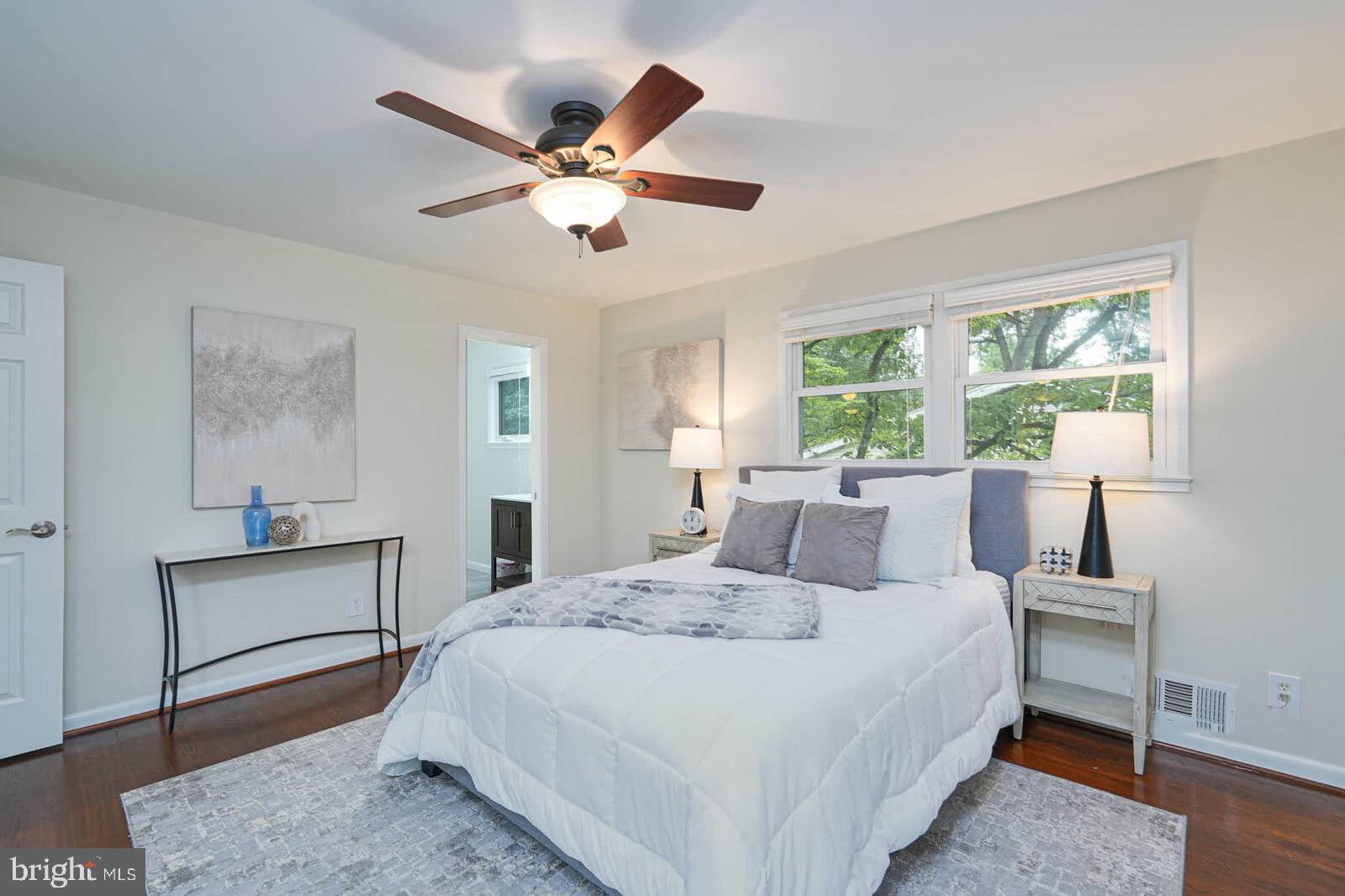 6511 Engel Drive McLean, VA 22101 - Photo 21 of 56 a bedroom with a large bed and a chandelier