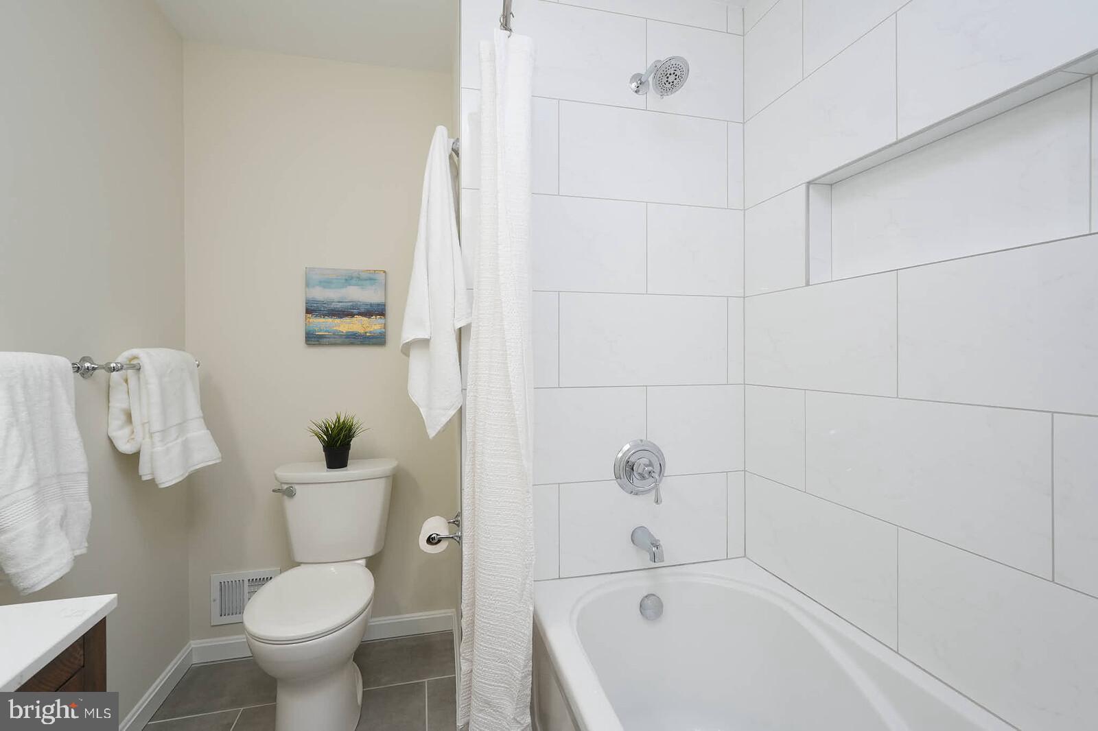 6511 Engel Drive McLean, VA 22101 - Photo 31 of 56 a bathroom with a toilet and shower