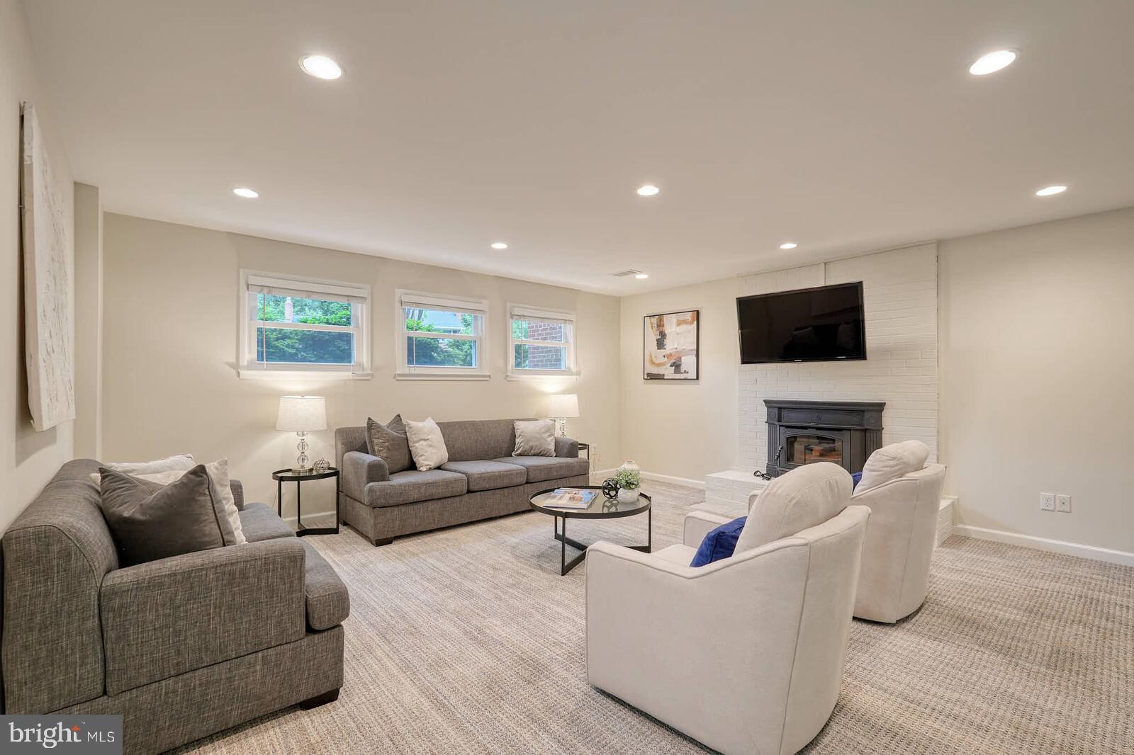 6511 Engel Drive McLean, VA 22101 - Photo 34 of 56 a living room with furniture a fireplace and a flat screen tv