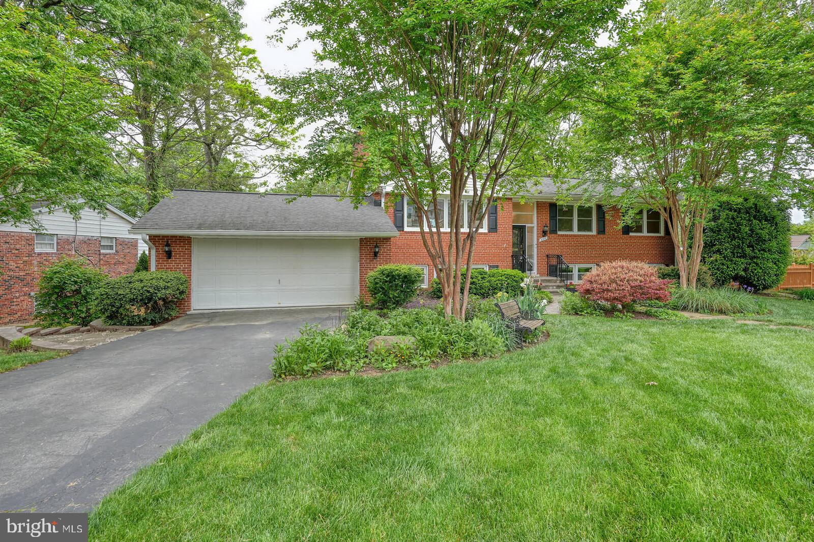 6511 Engel Drive McLean, VA 22101 - Photo 4 of 56 a front view of a house with garden and trees