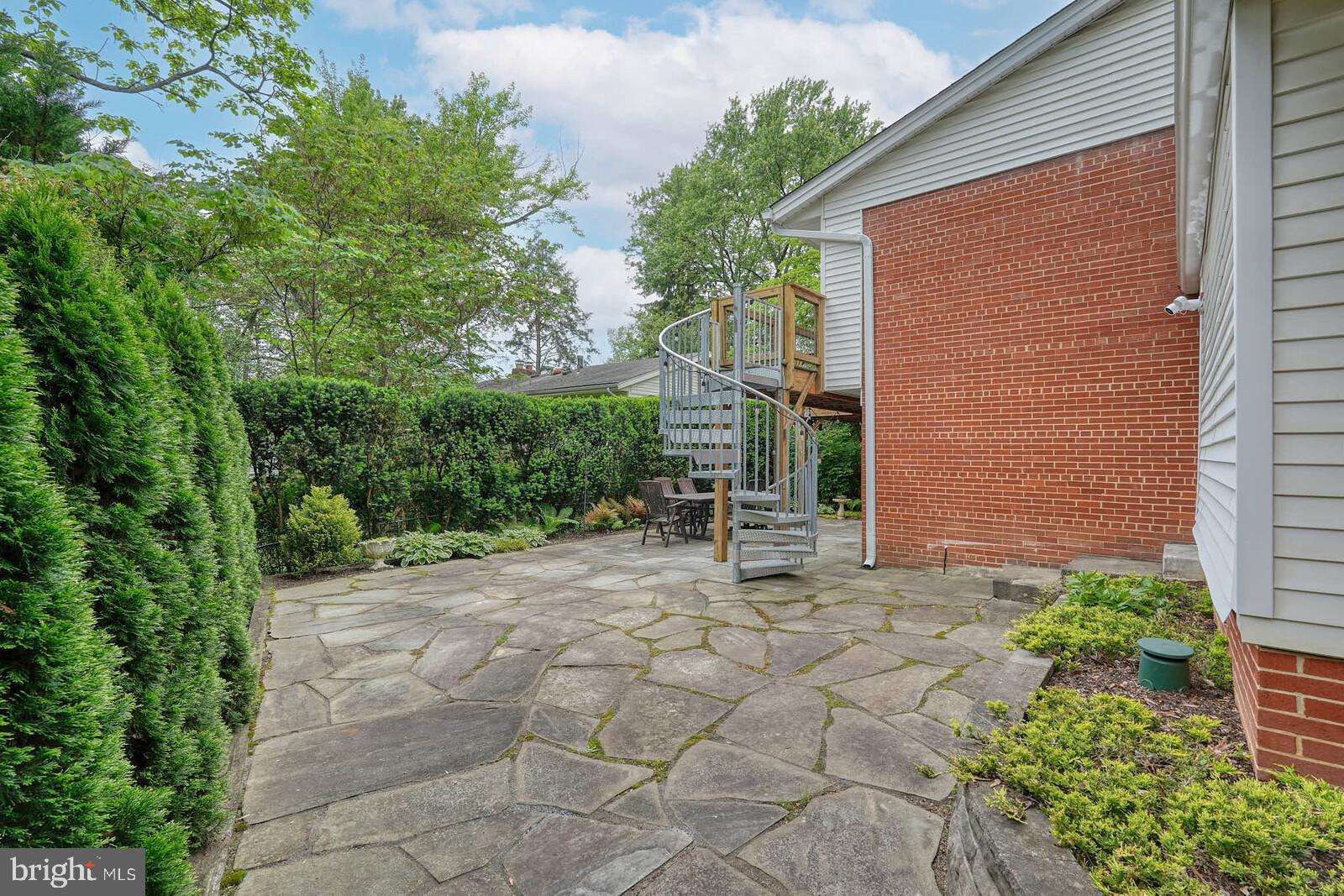 6511 Engel Drive McLean, VA 22101 - Photo 50 of 56 a view of a chair and table in the backyard of the house