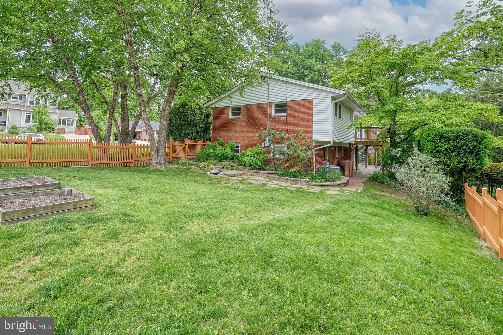 6511 Engel Drive McLean, VA 22101 - Photo 51 of 56 a view of a backyard with table and chairs and a large tree
