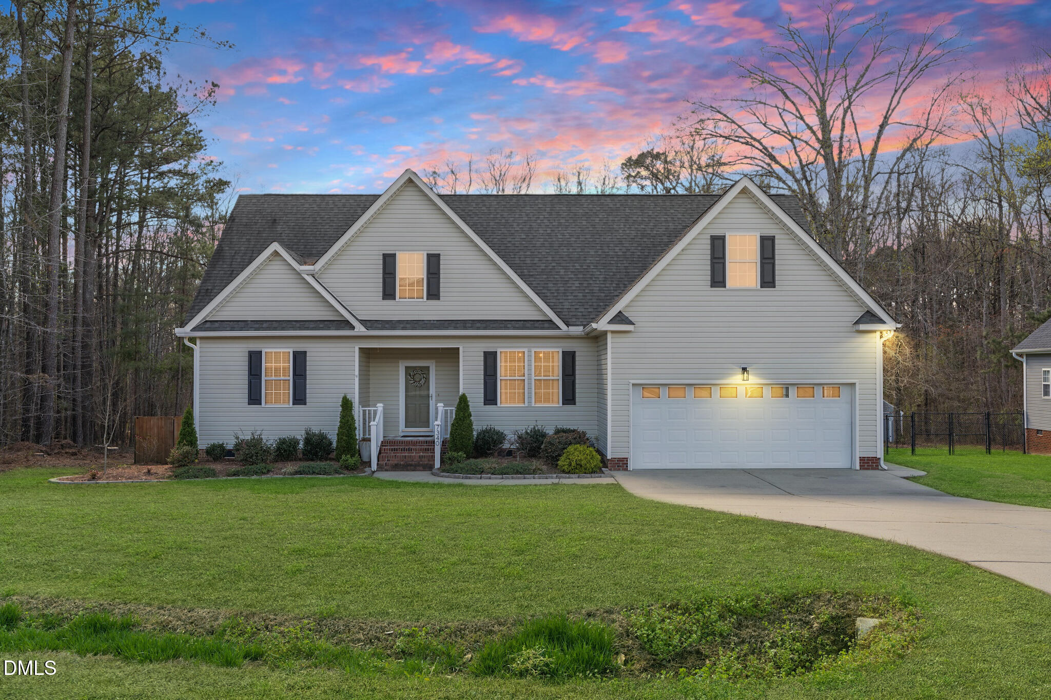 7340 Shady Stroll Lane Willow Spring, NC 27592 - Photo 1 of 67 a front view of a house with garden