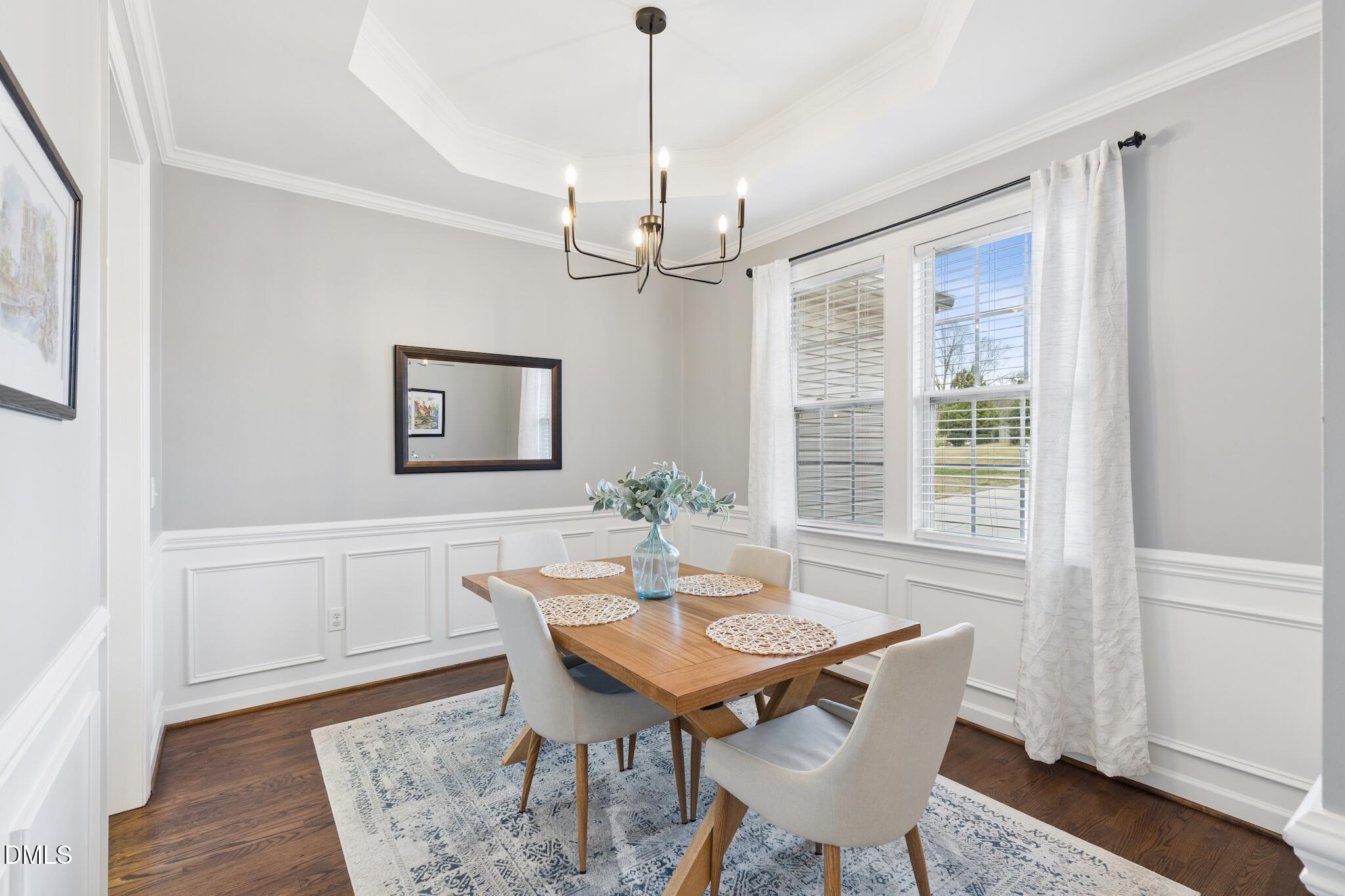 7340 Shady Stroll Lane Willow Spring, NC 27592 - Photo 22 of 67 a dining room with furniture a chandelier and wooden floor