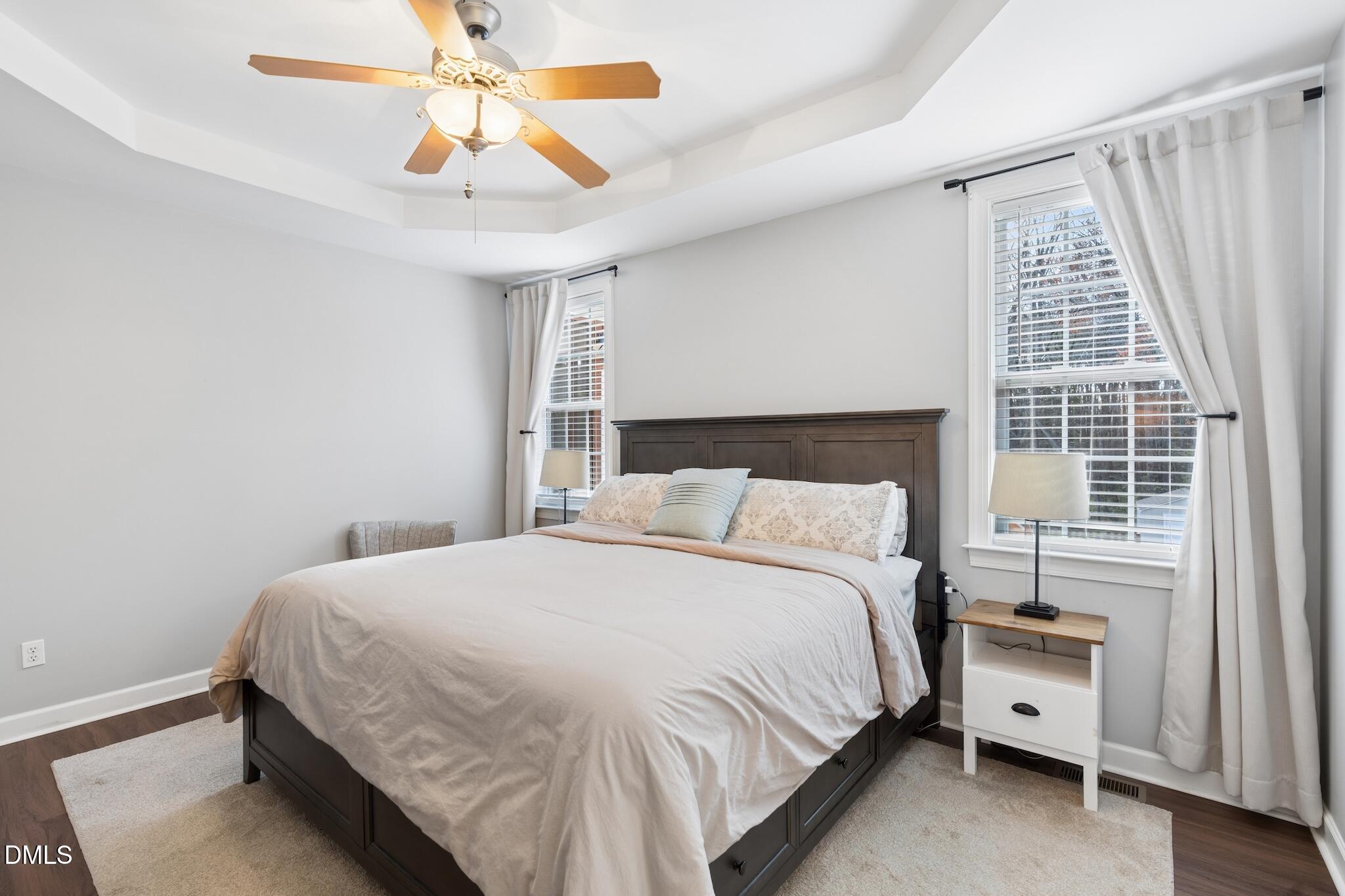 7340 Shady Stroll Lane Willow Spring, NC 27592 - Photo 27 of 67 a bedroom with a bed and a chandelier