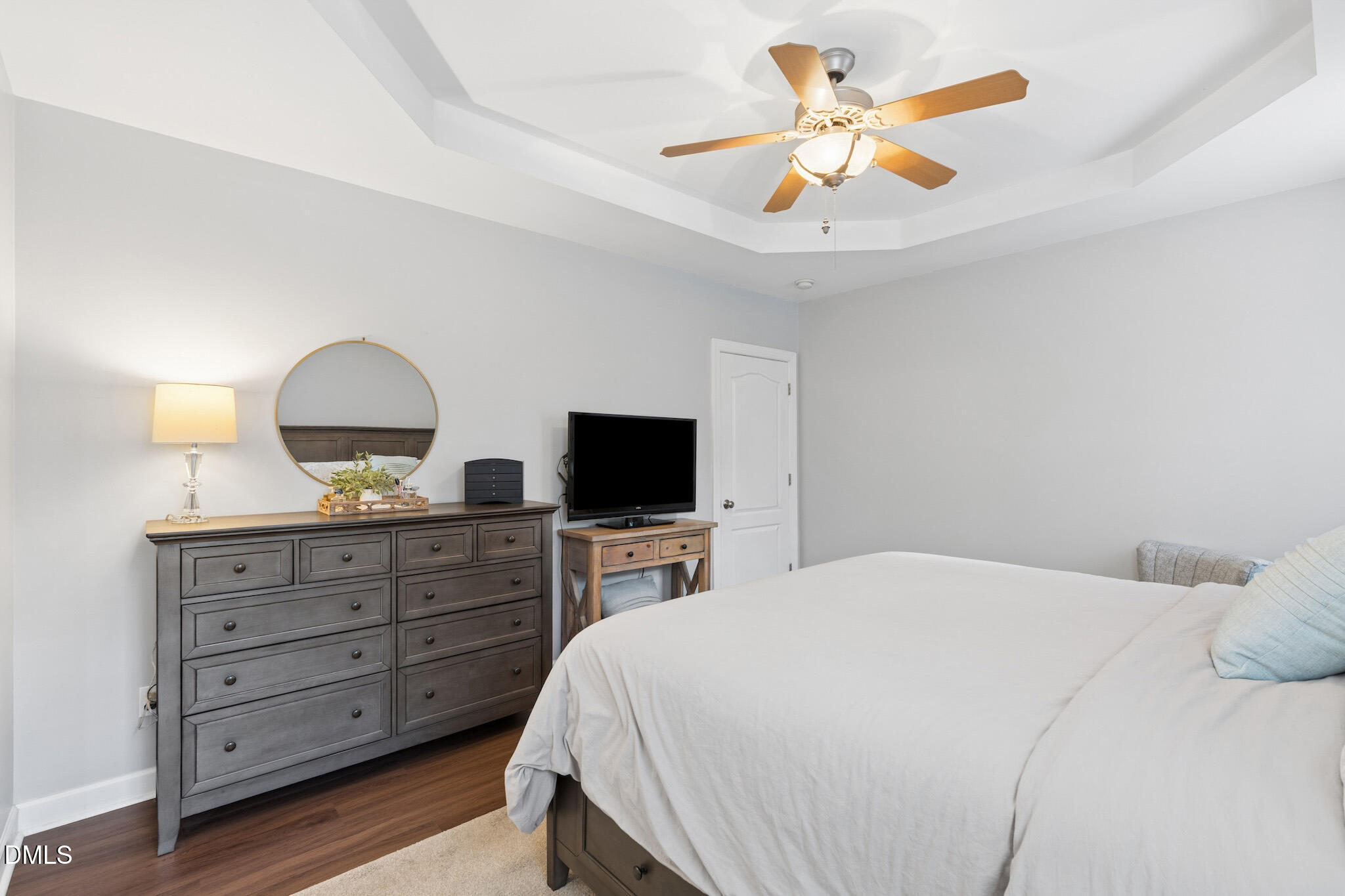 7340 Shady Stroll Lane Willow Spring, NC 27592 - Photo 29 of 67 a bedroom with a bed and a flat tv screen on dresser