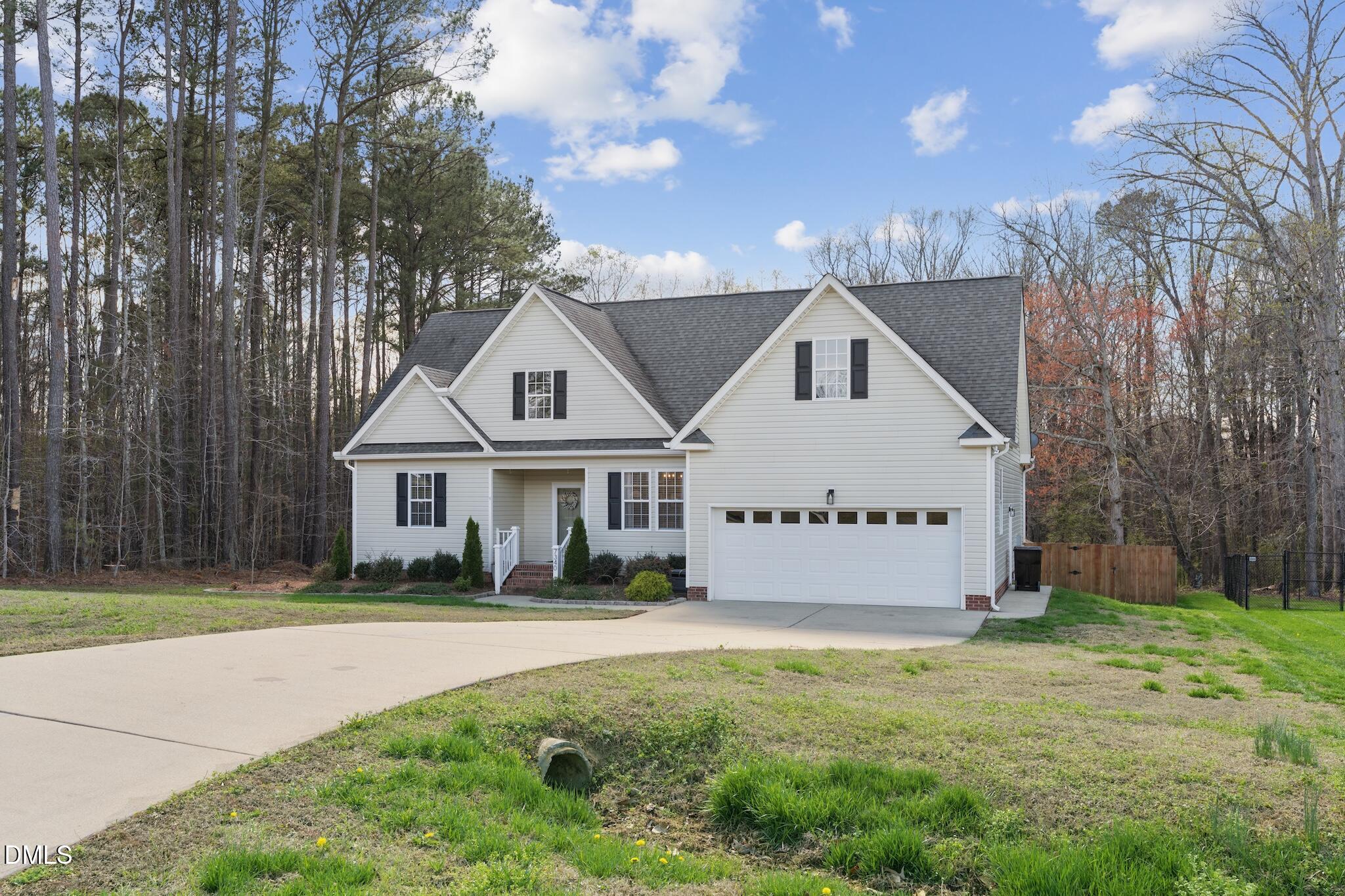 7340 Shady Stroll Lane Willow Spring, NC 27592 - Photo 3 of 67 a front view of a house with a garden