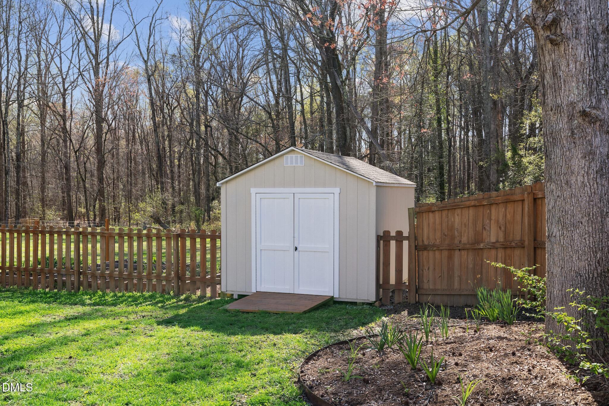 7340 Shady Stroll Lane Willow Spring, NC 27592 - Photo 56 of 67 a front view of a house with garden