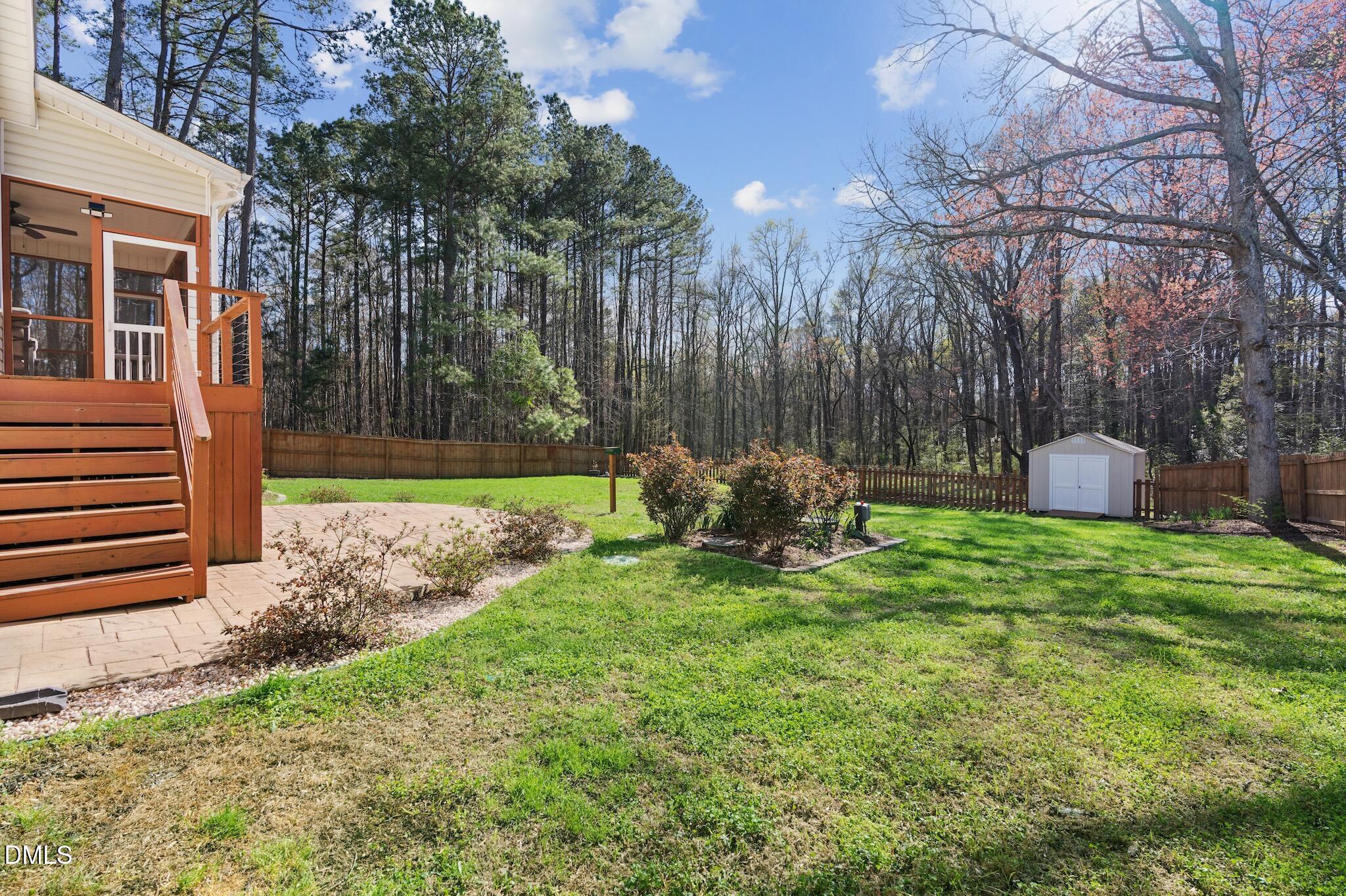 7340 Shady Stroll Lane Willow Spring, NC 27592 - Photo 58 of 67 a view of backyard with a barn and a large tree