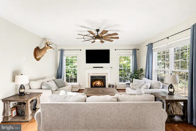 a living room with furniture a fireplace and a flat screen tv