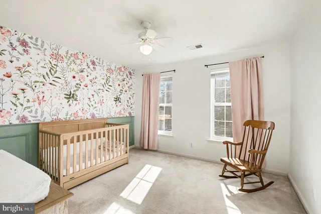 a view of a bedroom with furniture and windows