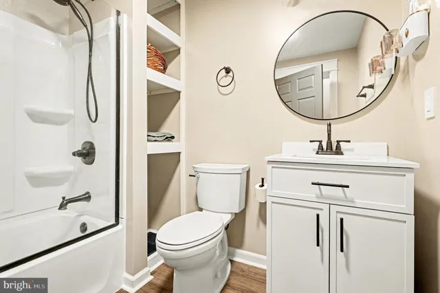 a bathroom with a sink a mirror a toilet and a mirror