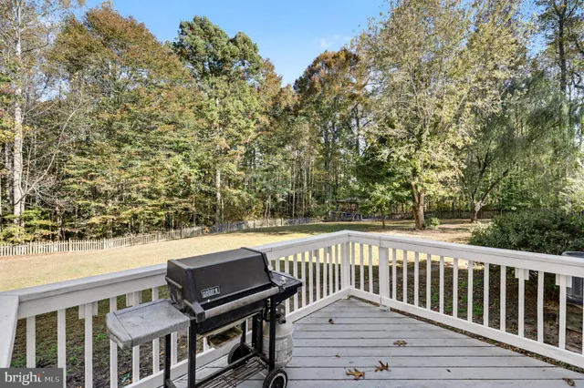 a view of a roof deck with wooden floor and fence