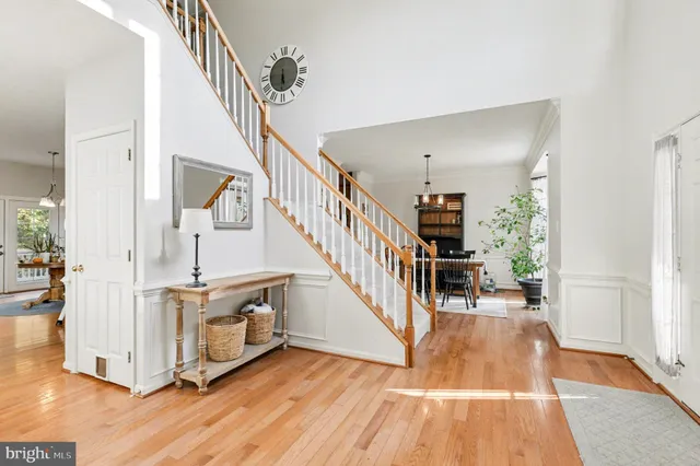a view of entryway and hall with wooden floor