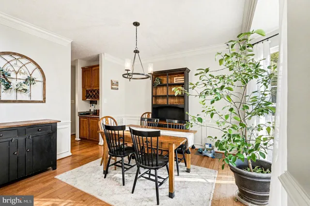 a view of a dining room with furniture and a potted plant
