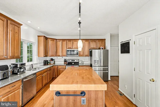 a kitchen with refrigerator a stove and cabinets