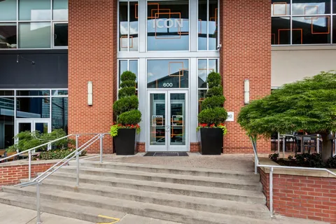 a living room with fireplace furniture and a large window