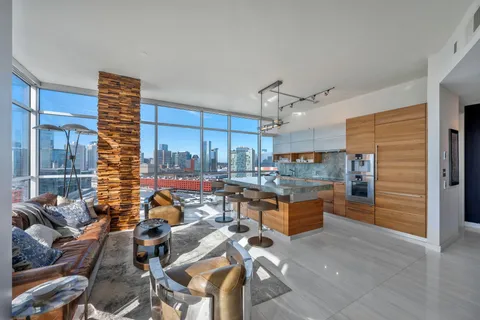 a living room with lots of furniture and kitchen view