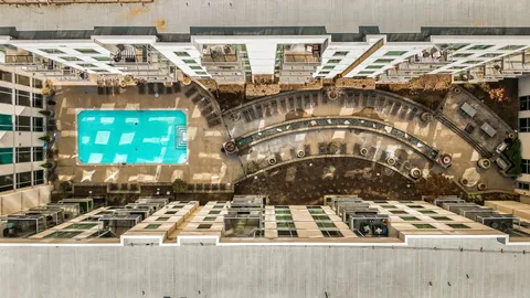 a view of a swimming pool with outdoor seating and plants