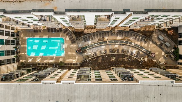 a view of a swimming pool with outdoor seating and plants