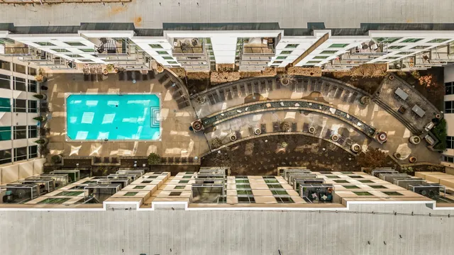 a view of a swimming pool with outdoor seating and plants