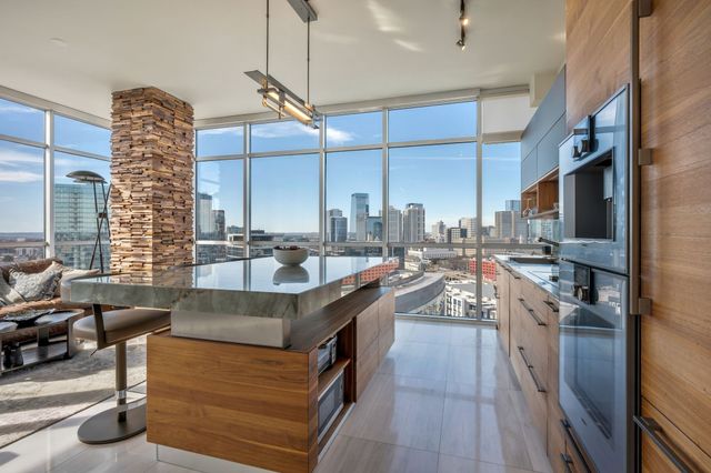 a kitchen with stainless steel appliances granite countertop a sink and a stove