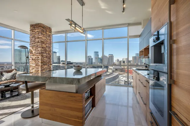 a kitchen with stainless steel appliances granite countertop a sink and a stove