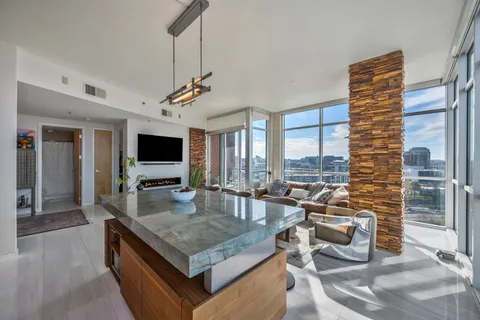 a kitchen with a stove a sink and a dining table