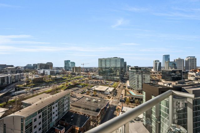 a bedroom with a bed and a flat tv screen on dresser