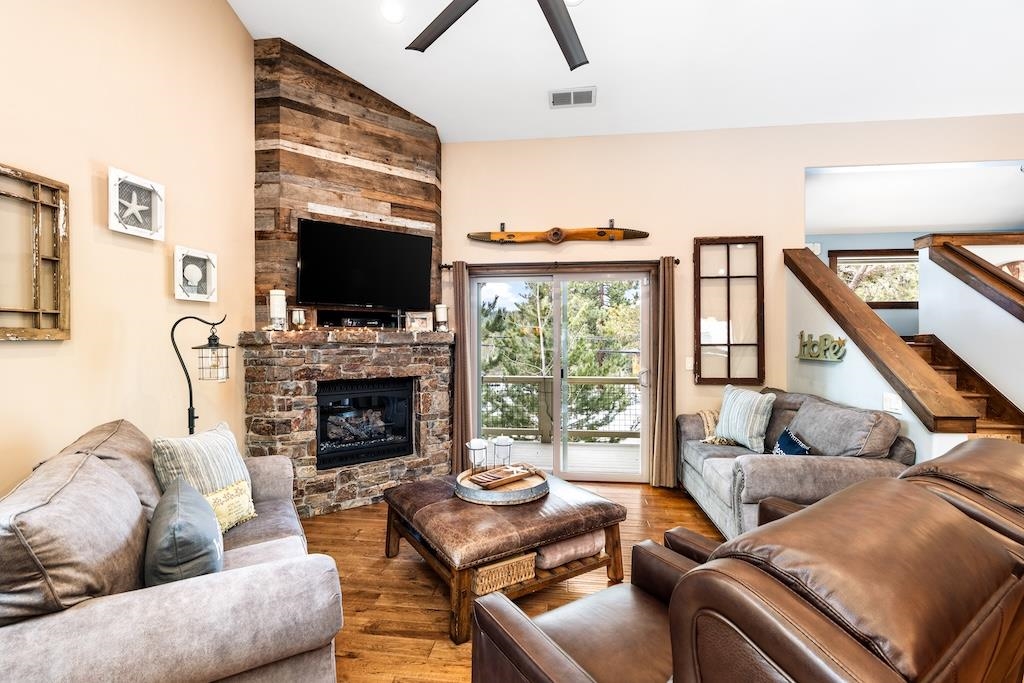 a living room with furniture a flat screen tv and a fireplace
