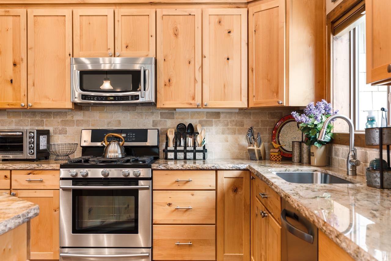 12719 Northwoods Boulevard Truckee, CA 96161 - Photo 11 of 28 a kitchen with stainless steel appliances granite countertop a sink a stove and a microwave