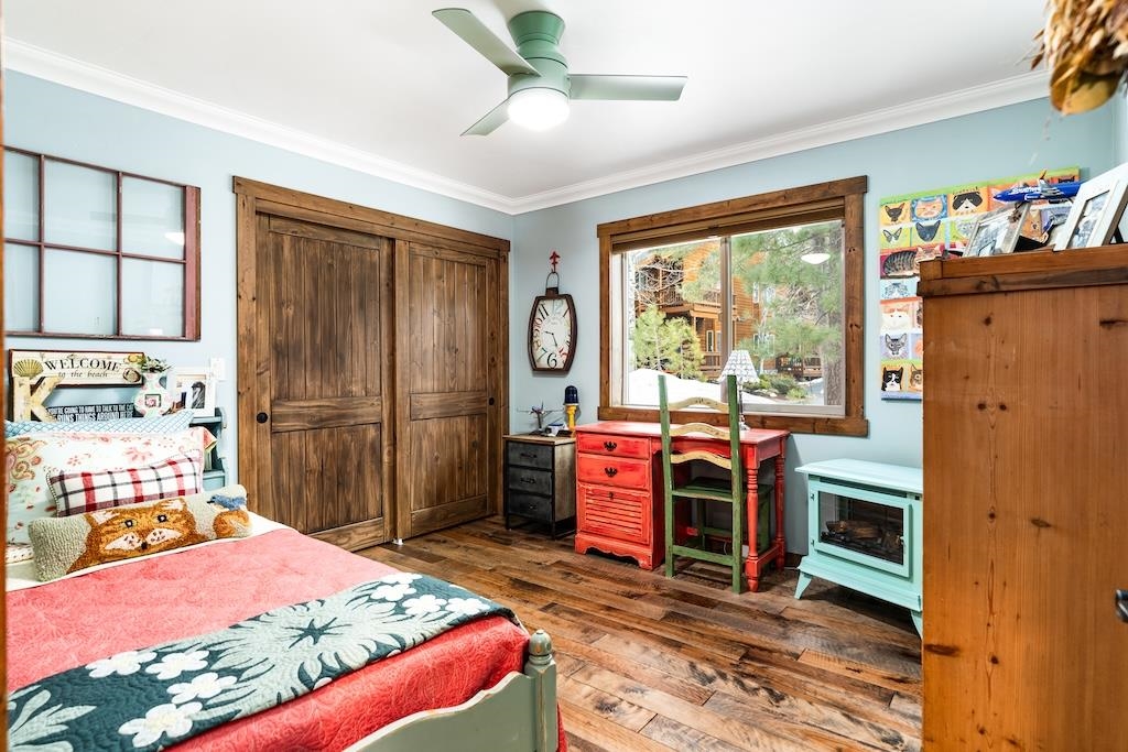 12719 Northwoods Boulevard Truckee, CA 96161 - Photo 16 of 28 a bedroom with a bed and a dresser next to a window