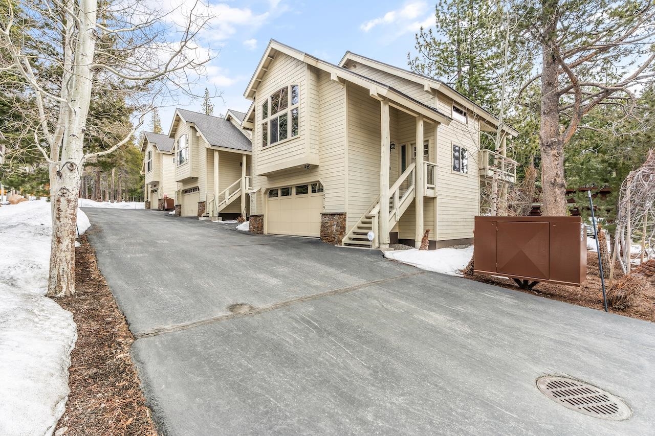 12719 Northwoods Boulevard Truckee, CA 96161 - Photo 2 of 28 a view of a white house with a large tree and wooden fence