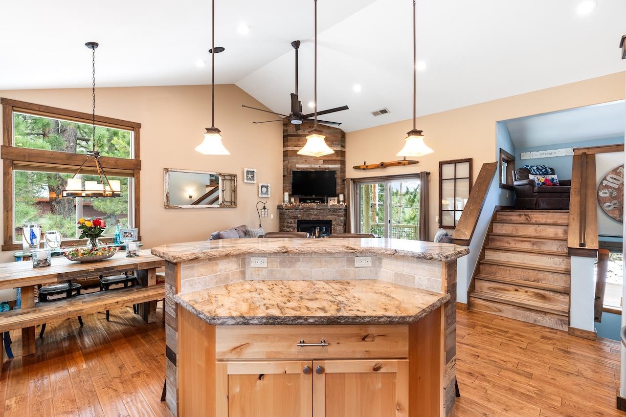 12719 Northwoods Boulevard Truckee, CA 96161 - Photo 6 of 28 a kitchen with stainless steel appliances granite countertop wooden floor and a view of living room