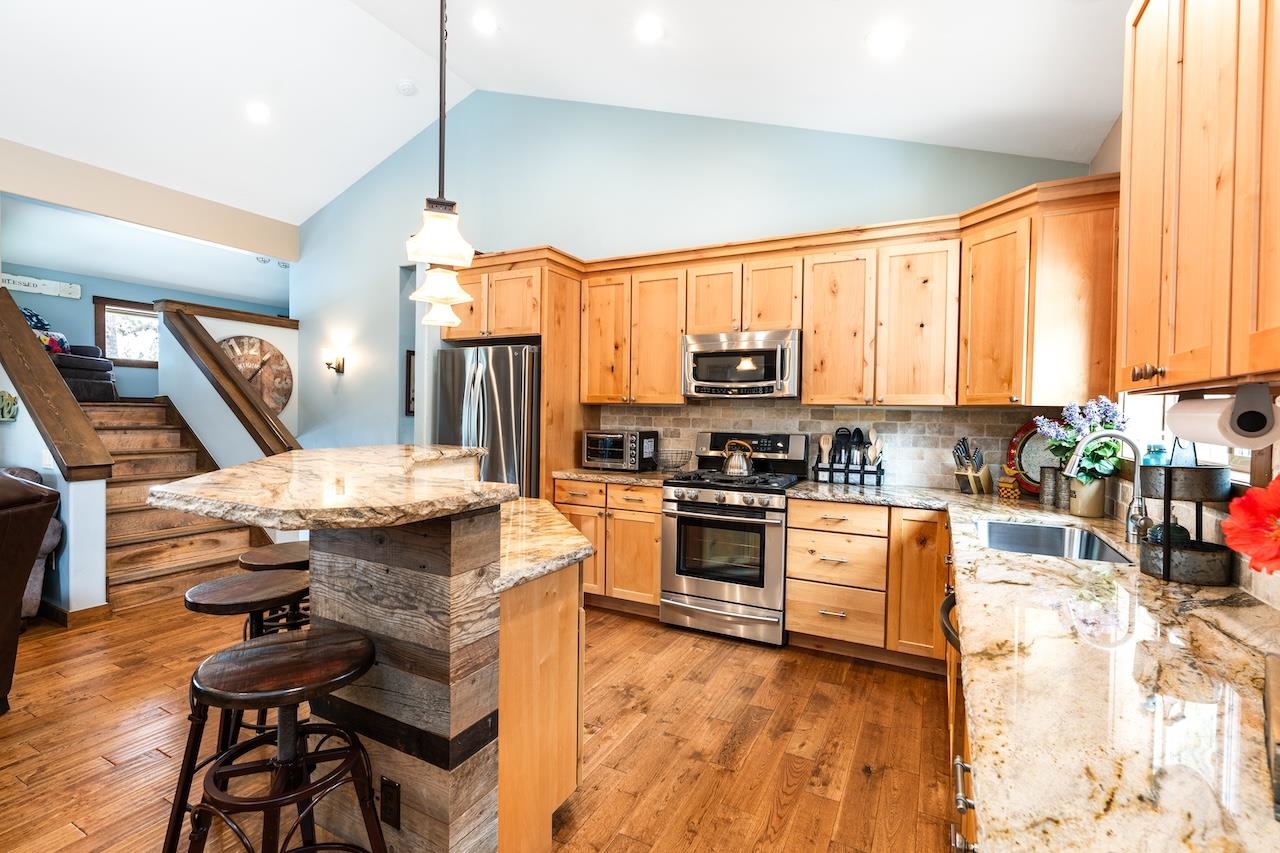 12719 Northwoods Boulevard Truckee, CA 96161 - Photo 10 of 28 a kitchen with stainless steel appliances granite countertop a stove refrigerator and a sink
