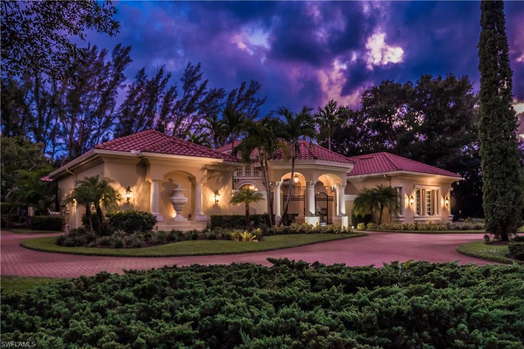 136 Hickory Road Naples, FL 34108 - Photo 32 of 34 Nighttime view of the home all lit up.