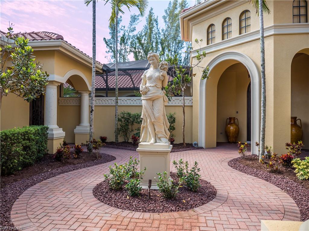 136 Hickory Road Naples, FL 34108 - Photo 7 of 34 Front entry courtyard with cabana entrance to the left and main home entry to the right.