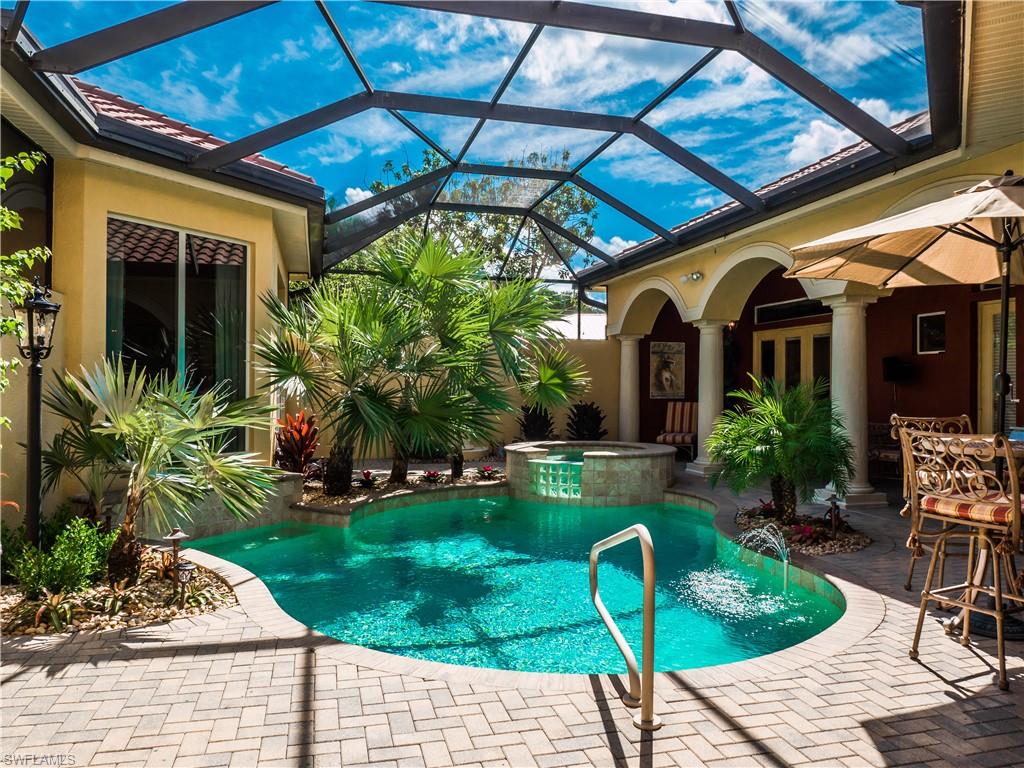 136 Hickory Road Naples, FL 34108 - Photo 9 of 34 Tropical pool and lanai with spa waterfall.