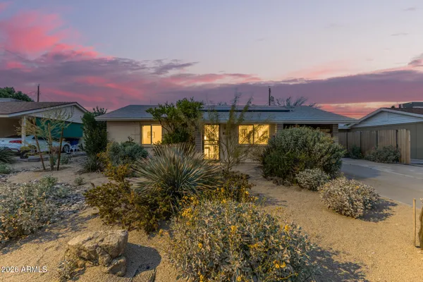 a view of a house with a yard and a garden