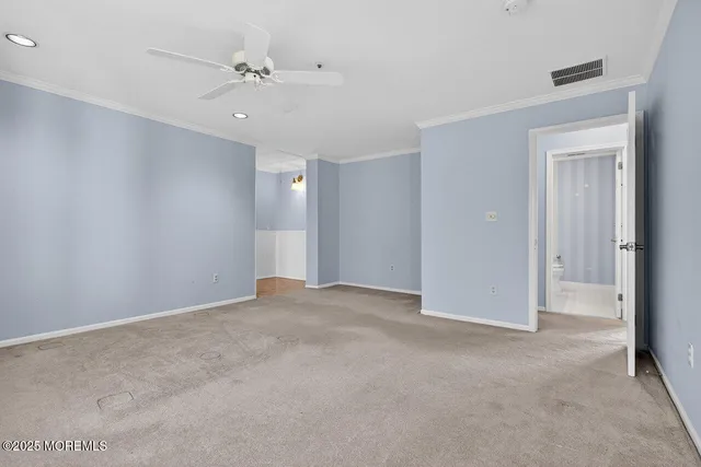a view of an empty room with a ceiling fan