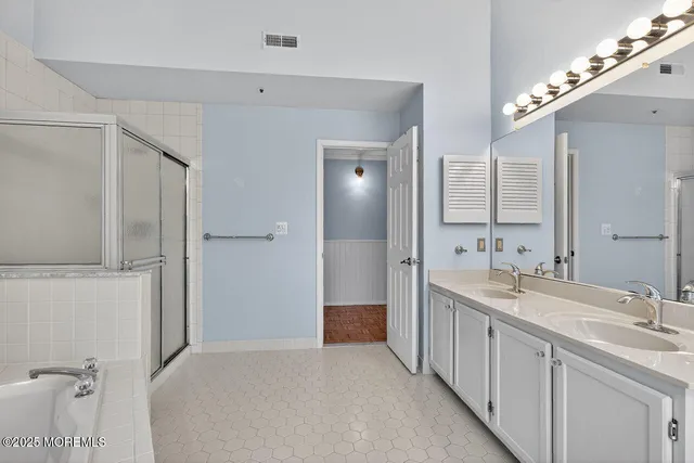 a bathroom with a double vanity sink and mirror