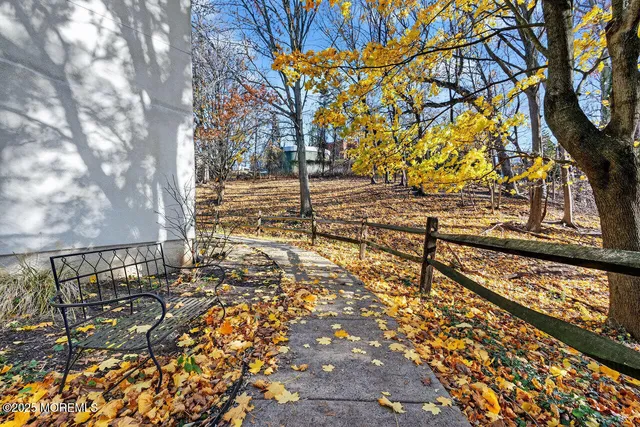 a view of a yard with wooden fence