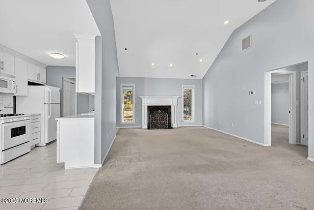 a view of kitchen and kitchen with a sink oven cabinets
