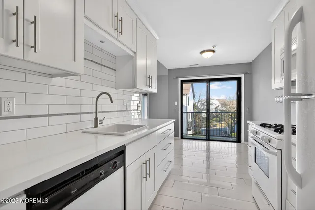 a kitchen with a sink stove and cabinets