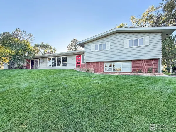 a view of a house with a yard and sitting area