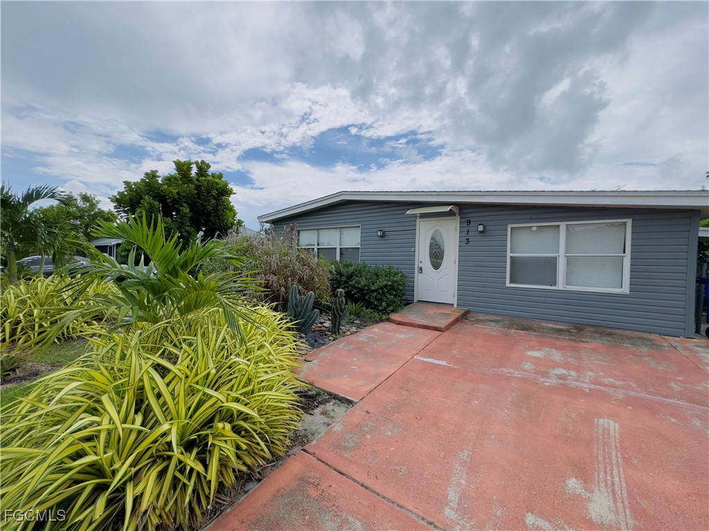 913 Hudson Avenue Lehigh Acres, FL 33936 - Photo 1 of 36 a house with a yard
