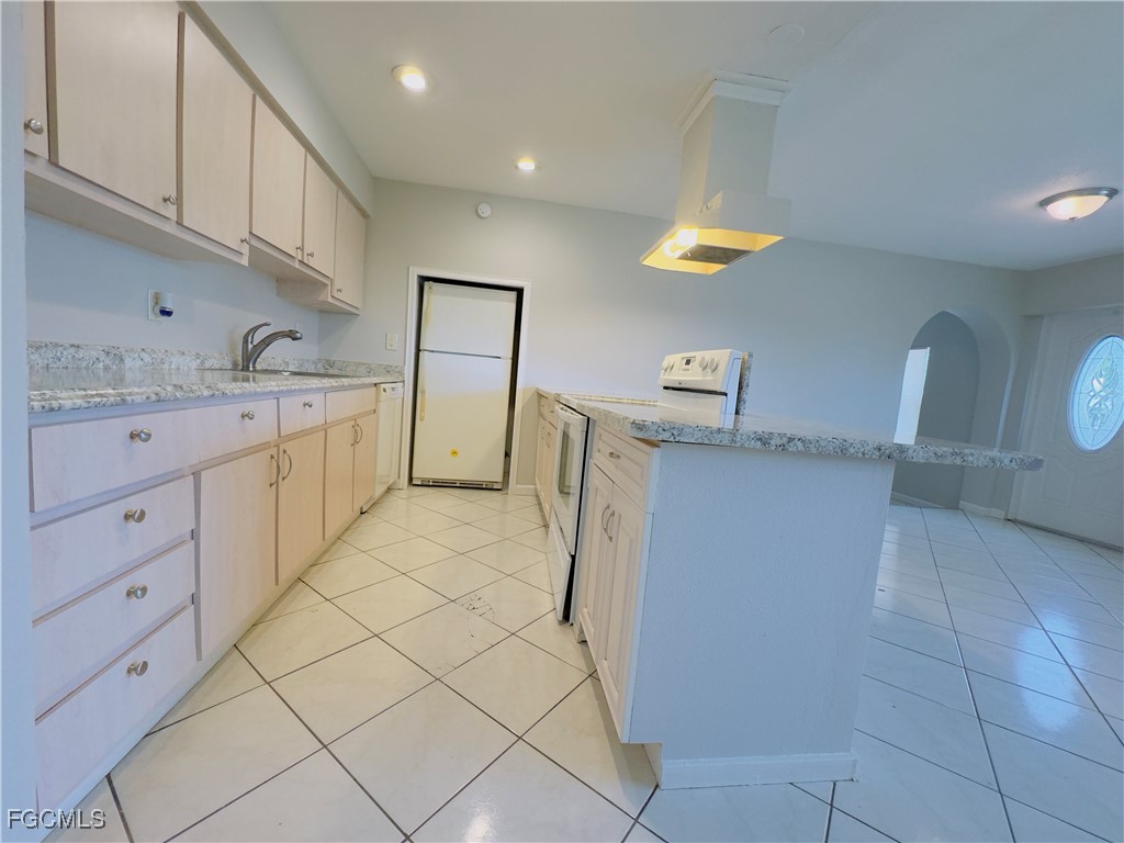 913 Hudson Avenue Lehigh Acres, FL 33936 - Photo 12 of 36 a kitchen with cabinets and window