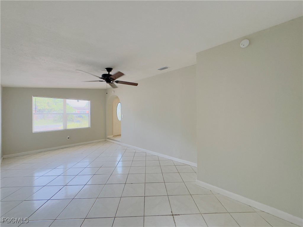 913 Hudson Avenue Lehigh Acres, FL 33936 - Photo 19 of 36 an empty room with windows and ceiling fan