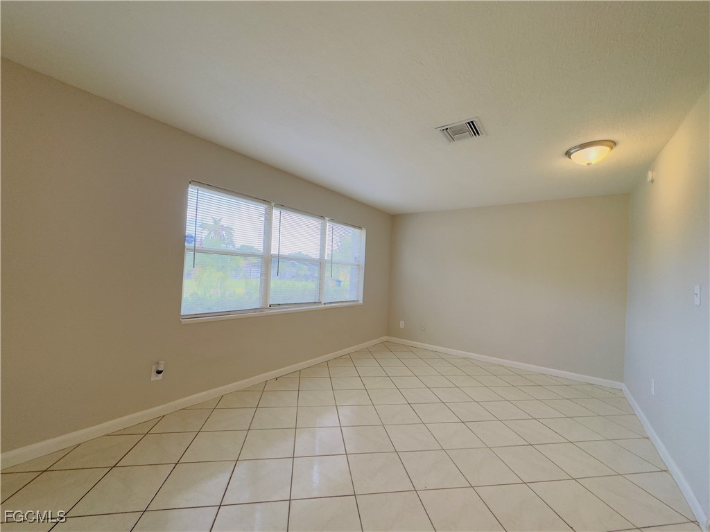 913 Hudson Avenue Lehigh Acres, FL 33936 - Photo 2 of 36 a view of an empty room with a window